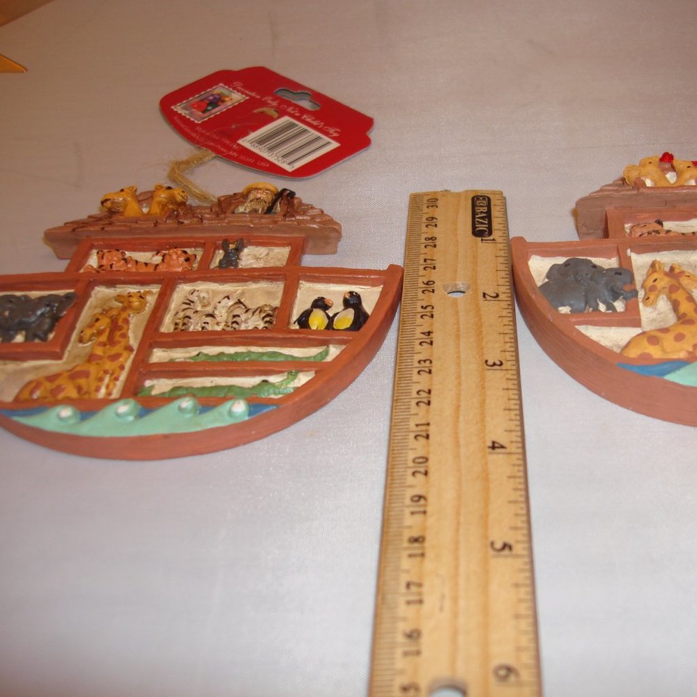 Noah's Ark Vintage 2 ornaments appear to be looking at Noah and animals in Ark